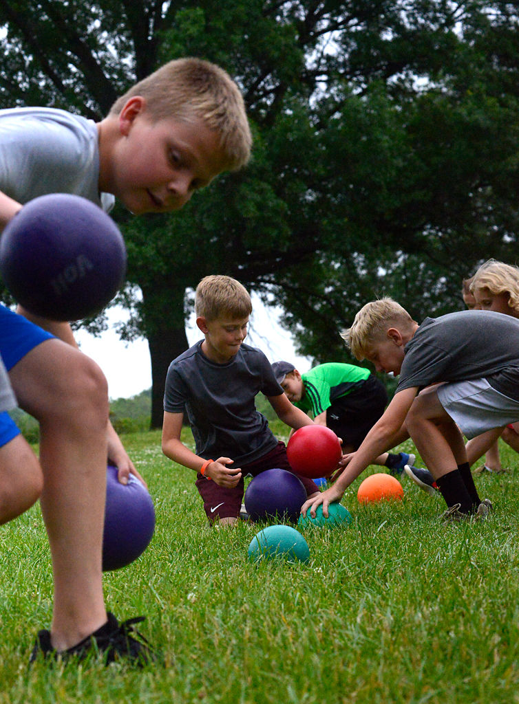 Campers run up and snatch dodgeballs at the beginning of the game
